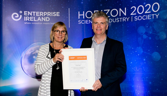 Enterprise Ireland’s CEO Julie Sinnamon presenting a Horizon 2020 Champions of EU Research outstanding achievement award to Tindall’s Dr Peter O’Brien. (Fennell Photography)