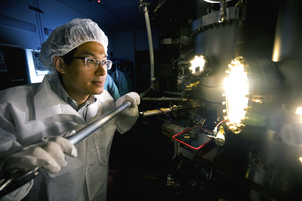 Zetian Mi, professor of Electrical Engineering and Computer Science, produces a sample in the MBE machine. (Image credit: Joseph Xu, Michigan Engineering.) 